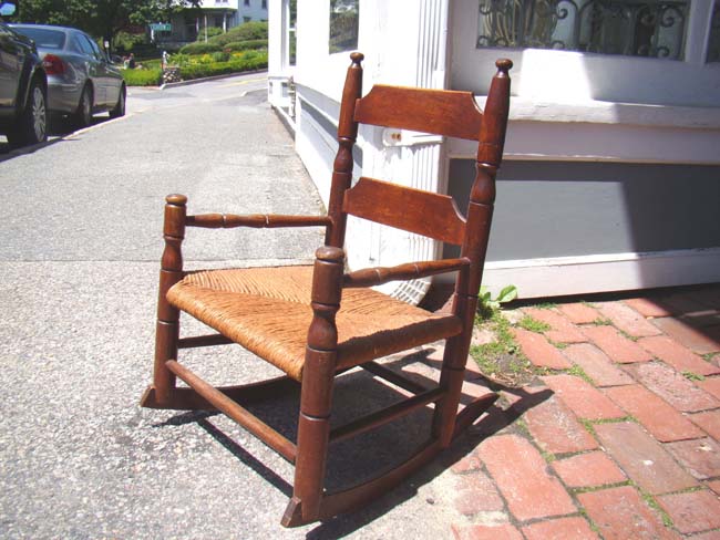 A wonderful 19th century elm and oak childs' rocking chair with rush seat.